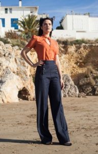 orange key hold blouse with dark blue wide leg sailor pants